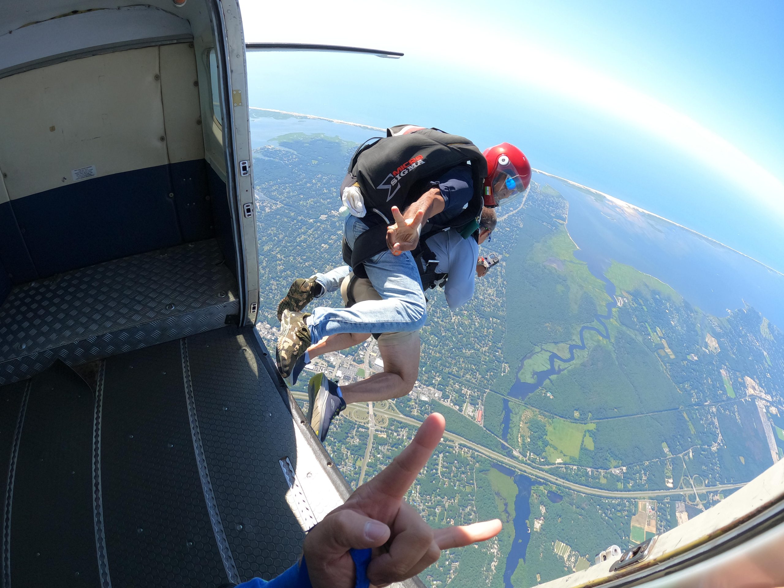 jumping out of a skydiving airplane with tandem instructor