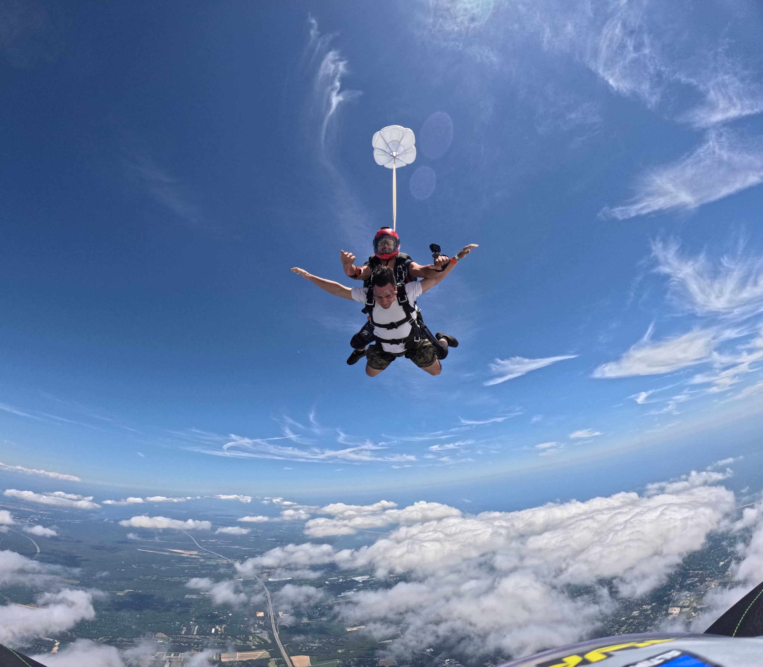 skydiver free falling attached to skydiving instructor