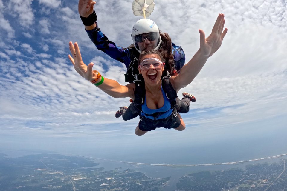 woman skydiving with open arms during freefall