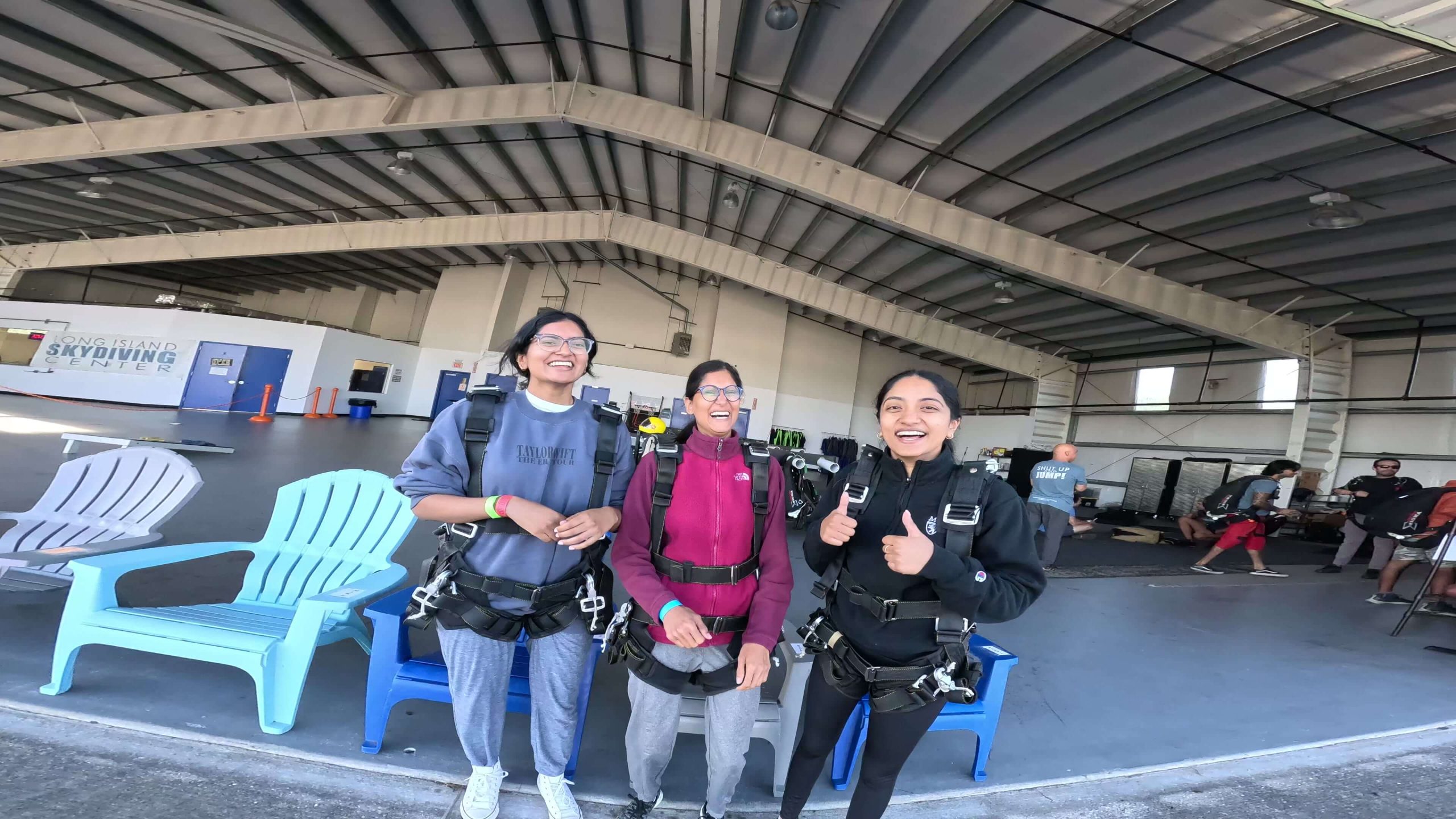 Group of 3 excited and ready to go on a plane for an skydiving adventure.