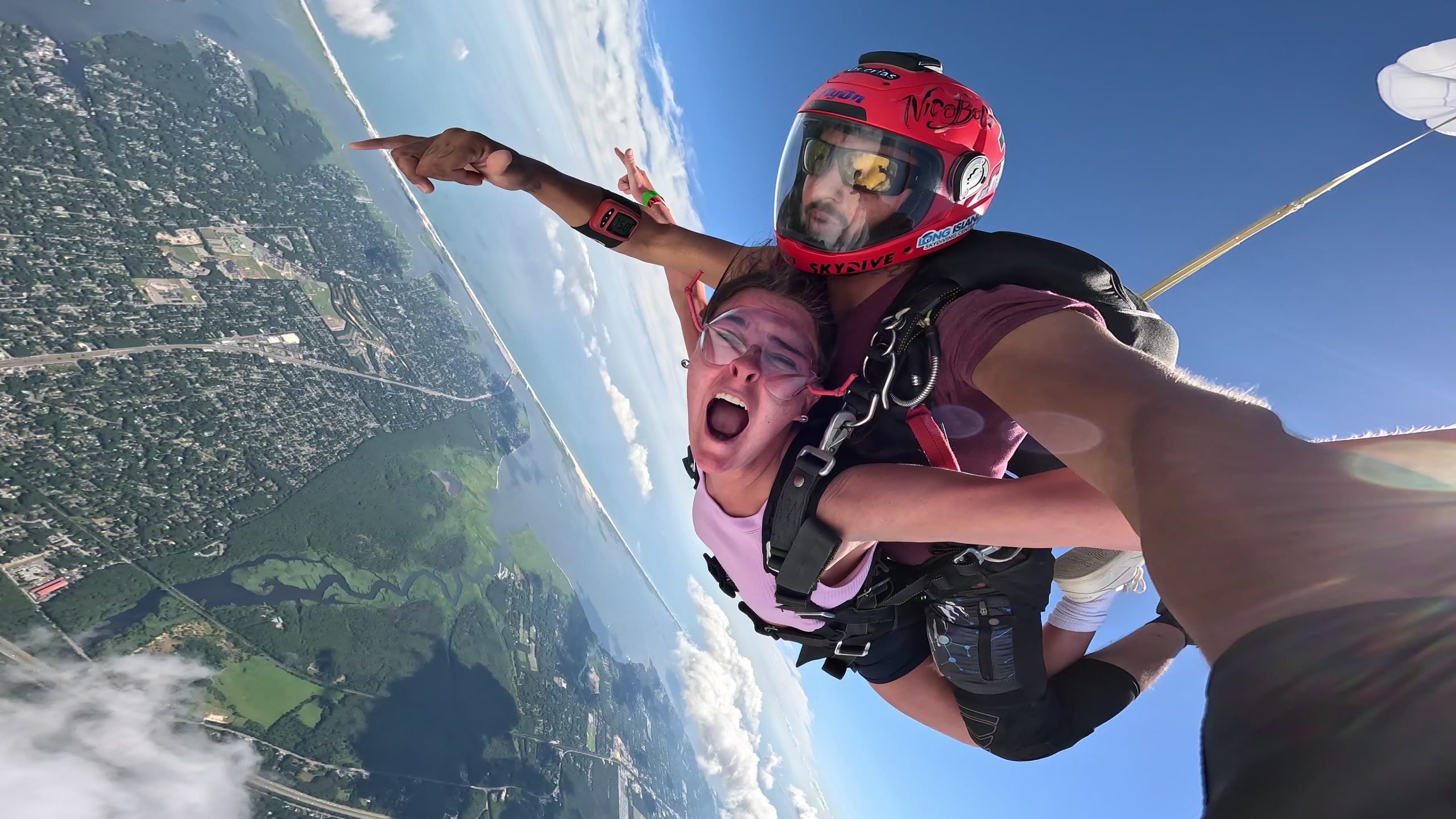 woman skydiving attached to a skydiving instructor