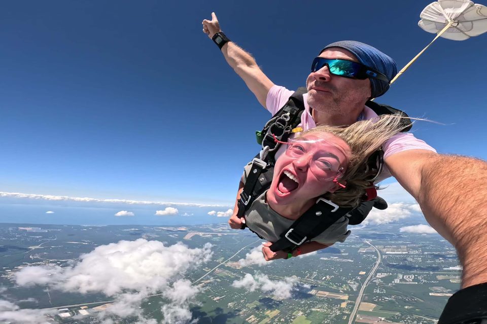 Happy girl skydiving by the New York coastline