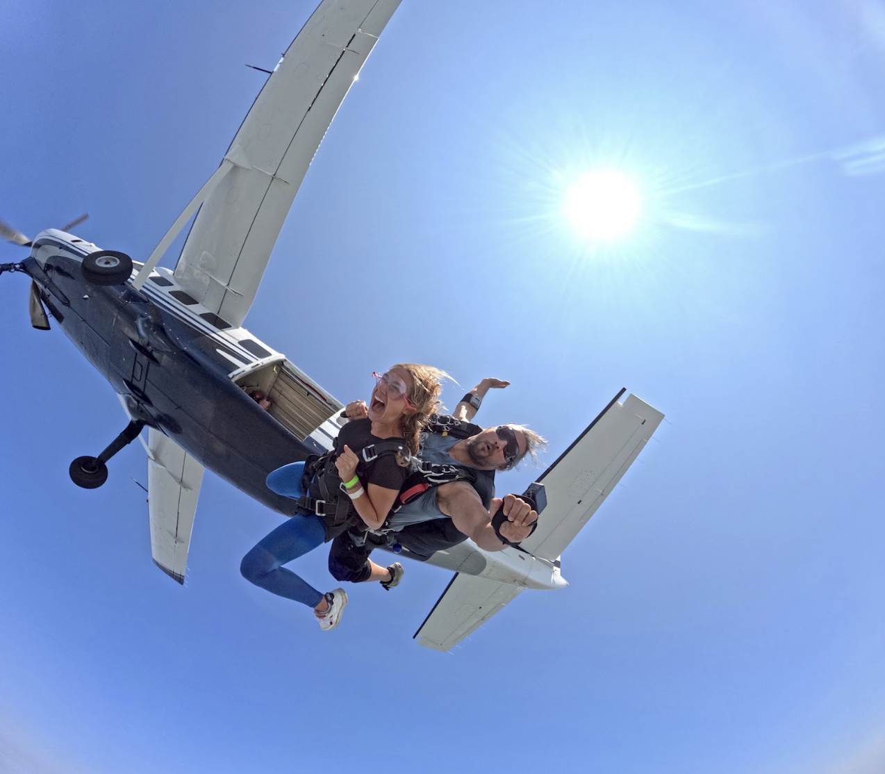 tandem skydiving woman jumping off plane