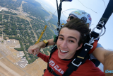 young man attached to skydiving instructor skydiving over long island